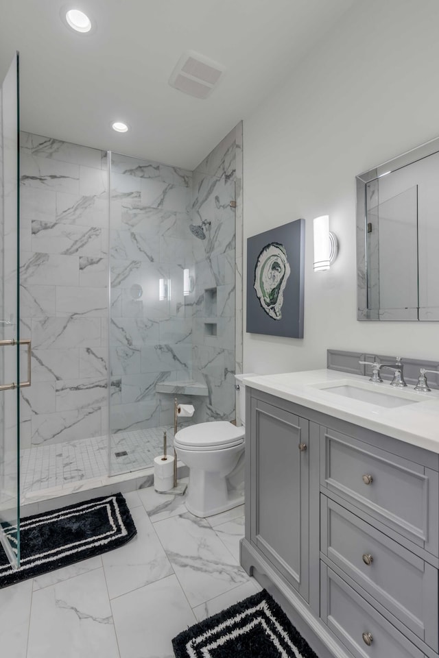 bathroom with an enclosed shower, vanity, and toilet