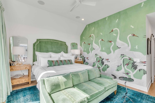 bedroom with ceiling fan, hardwood / wood-style flooring, and vaulted ceiling