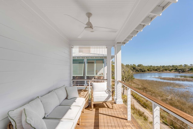 balcony featuring a water view, an outdoor living space, and ceiling fan