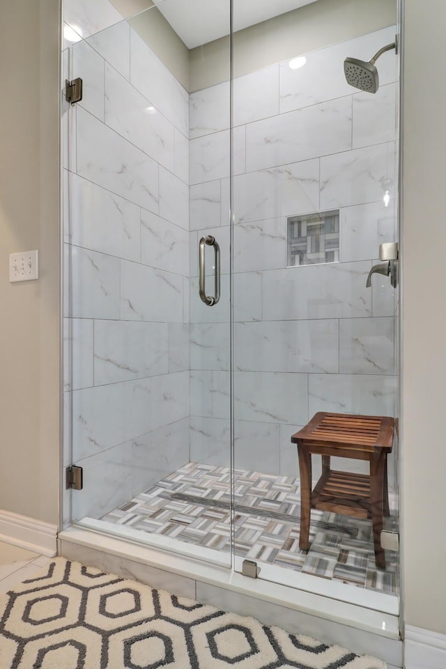 bathroom featuring a shower with shower door