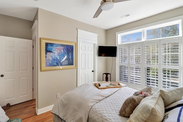 bedroom with light hardwood / wood-style flooring and ceiling fan