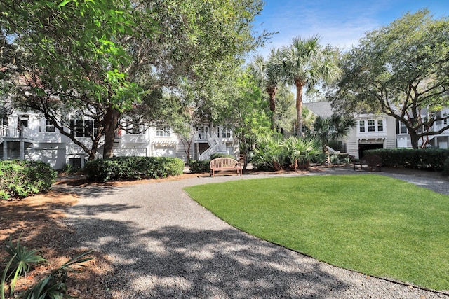 view of property's community with a lawn