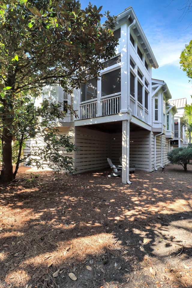 view of side of property featuring a sunroom