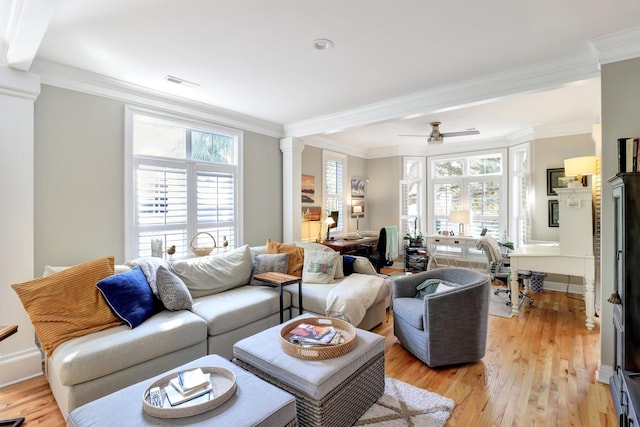 living room featuring crown molding, ceiling fan, decorative columns, and light hardwood / wood-style flooring