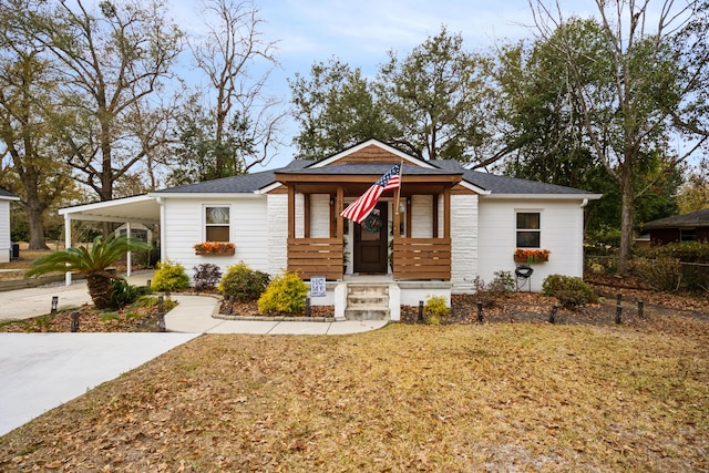 view of front facade with a front yard and a carport