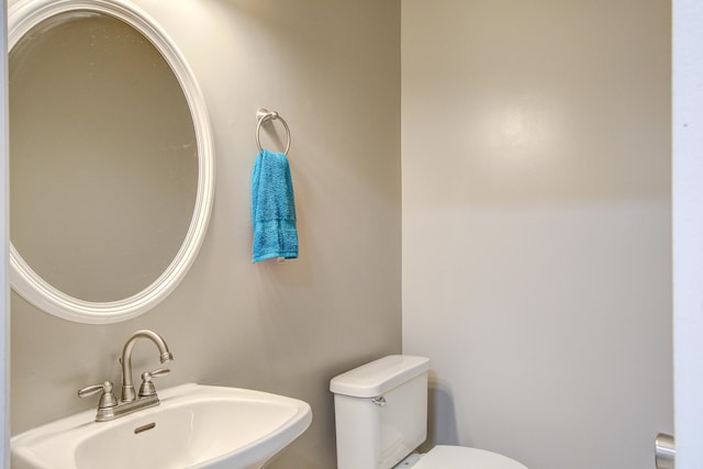 half bathroom featuring a sink and toilet