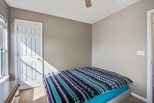 bedroom with carpet floors, baseboards, and a ceiling fan