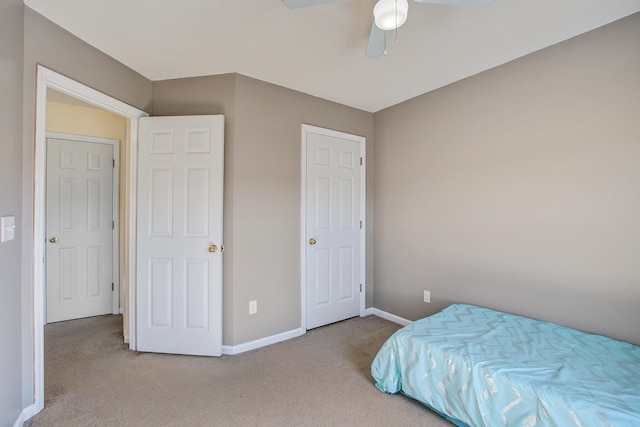 bedroom with ceiling fan, baseboards, and carpet flooring