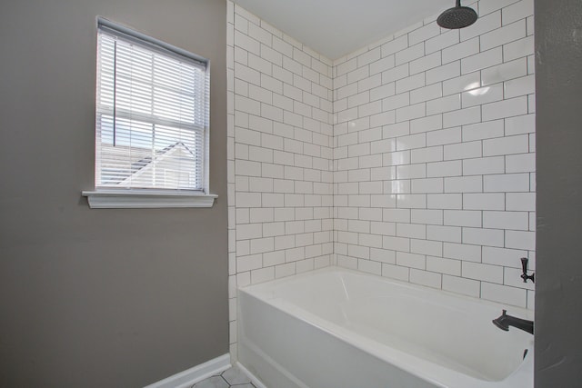 bathroom with tub / shower combination and baseboards