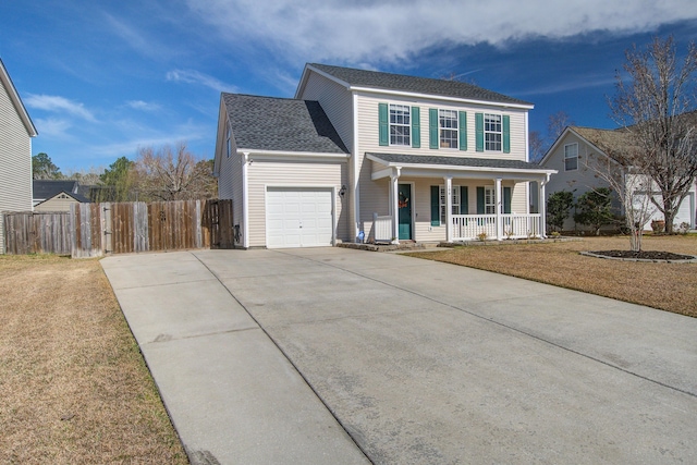 view of front facade with covered porch, concrete driveway, an attached garage, fence, and a front lawn