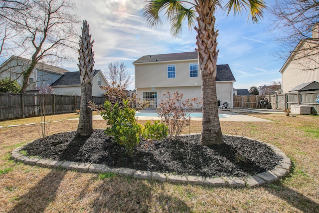 back of property with a fenced backyard, a patio, and a lawn