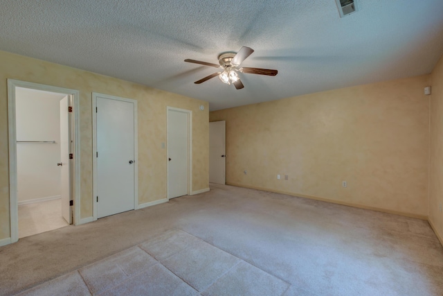 441 Compton Dr, Moncks Corner, SC 29461 - unfurnished bedroom featuring carpet, baseboards, two closets, ceiling fan, and a textured ceiling