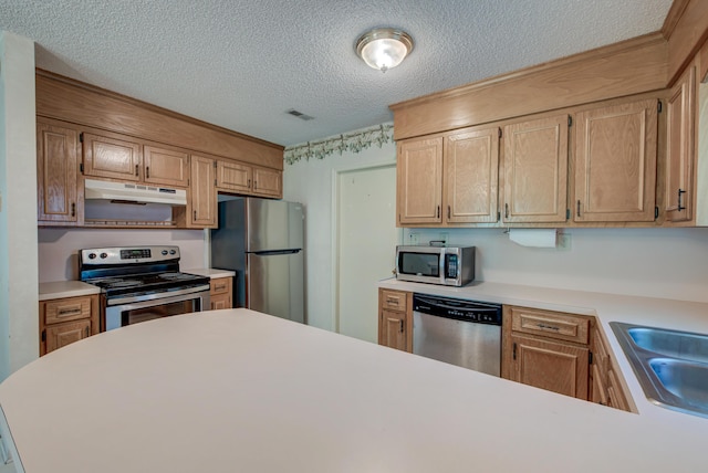 441 Compton Dr, Moncks Corner, SC 29461 - kitchen featuring stainless steel appliances, under cabinet range hood, a textured ceiling, light countertops, and a sink