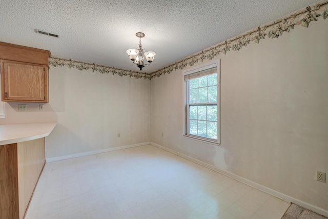 441 Compton Dr, Moncks Corner, SC 29461 - unfurnished dining area featuring a chandelier, a textured ceiling, light flooring, and baseboards