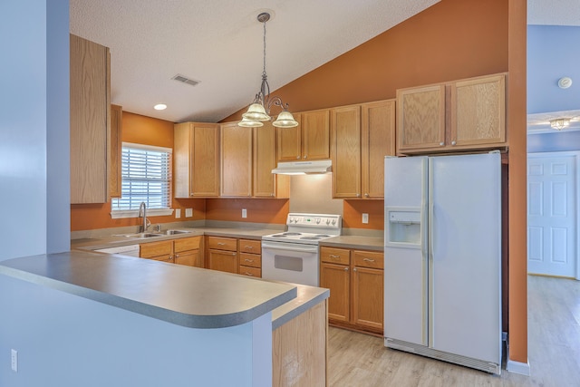 kitchen with white appliances, visible vents, a peninsula, a sink, and under cabinet range hood