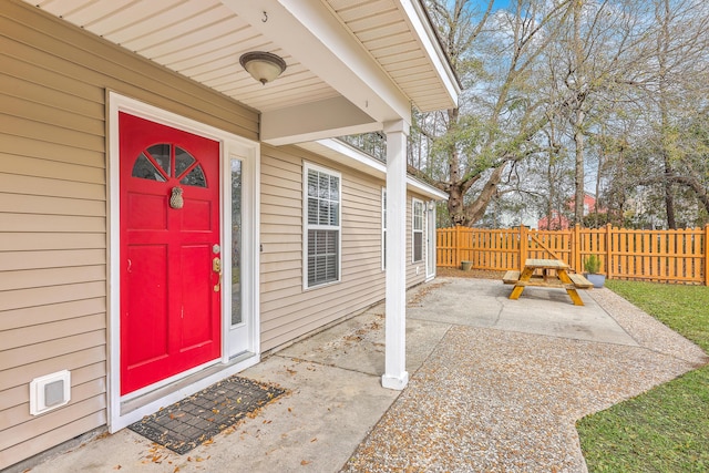 entrance to property with a patio and fence