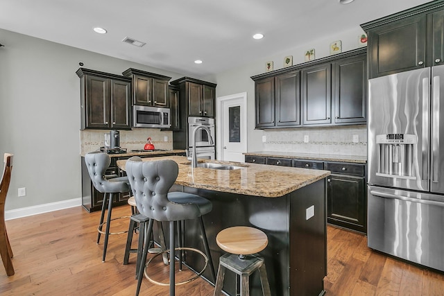 219 Daybreak Blvd, Summerville, SC 29486 - kitchen with visible vents, light wood-style flooring, stainless steel appliances, and a sink