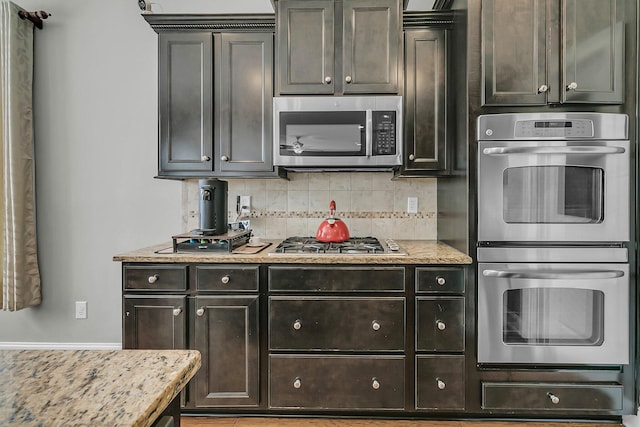 219 Daybreak Blvd, Summerville, SC 29486 - kitchen featuring light stone counters, backsplash, stainless steel appliances, and a warming drawer