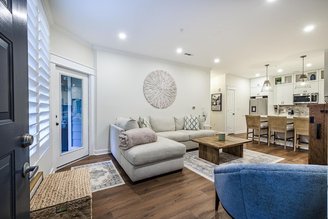 living room with dark wood-type flooring and ornamental molding