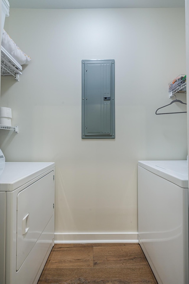 washroom featuring washer and dryer, dark hardwood / wood-style flooring, and electric panel