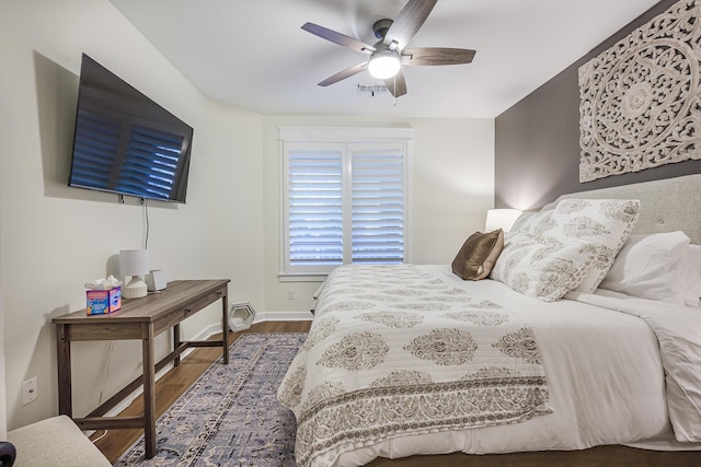 bedroom with ceiling fan and dark hardwood / wood-style floors