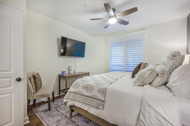 bedroom with ceiling fan and dark wood-type flooring