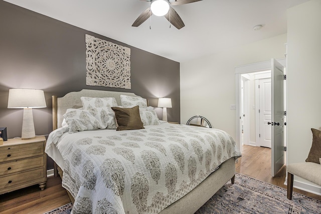 bedroom with ceiling fan and wood-type flooring