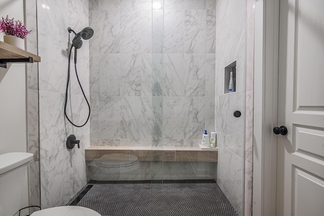 bathroom featuring toilet and tiled shower