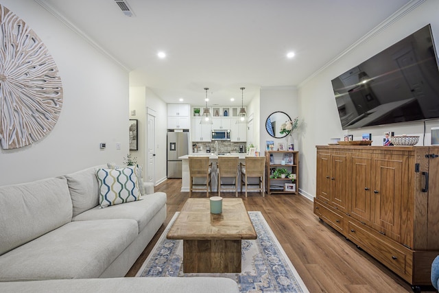 living room with ornamental molding and dark wood-type flooring