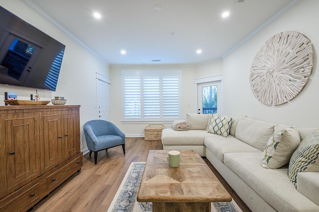 living room with light wood-type flooring and crown molding