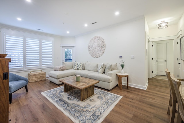 living room with ornamental molding and dark hardwood / wood-style floors