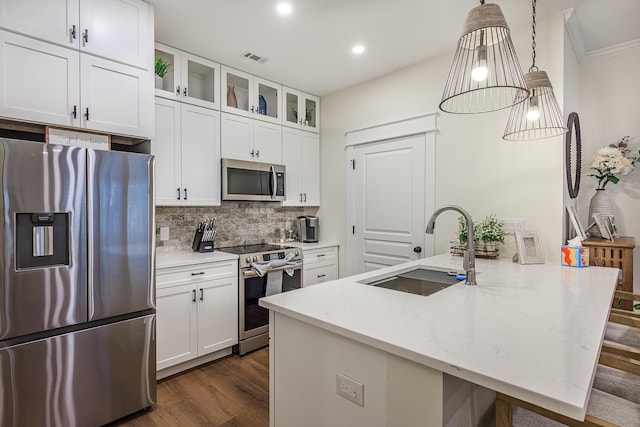 kitchen featuring light stone countertops, hanging light fixtures, stainless steel appliances, white cabinets, and sink