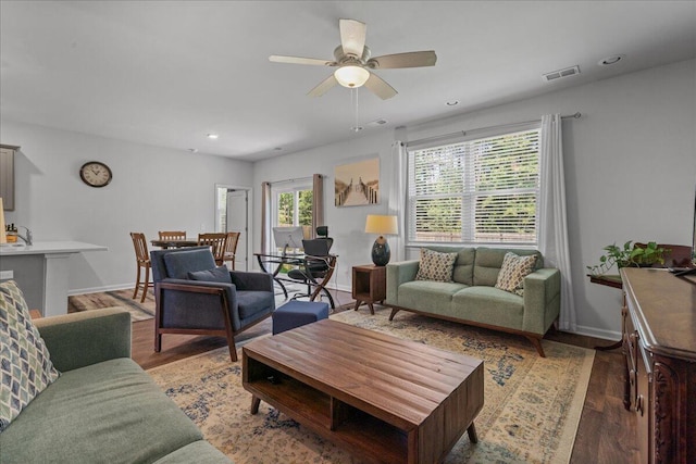 living room with hardwood / wood-style floors and ceiling fan