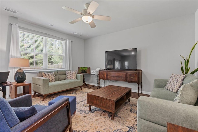 living room with ceiling fan and light hardwood / wood-style floors