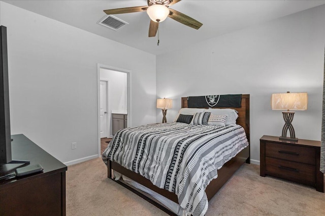 carpeted bedroom featuring ceiling fan and ensuite bath