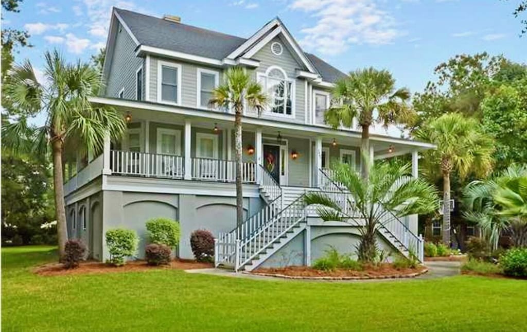 1447 Headquarters Plantation Dr, Johns Island, SC 29455 - raised beach house with stairs, covered porch, and a front yard