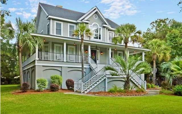 1447 Headquarters Plantation Dr, Johns Island, SC 29455 - raised beach house with stairs, covered porch, and a front yard