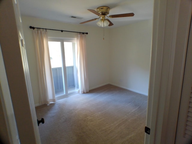 unfurnished room with light colored carpet and ceiling fan