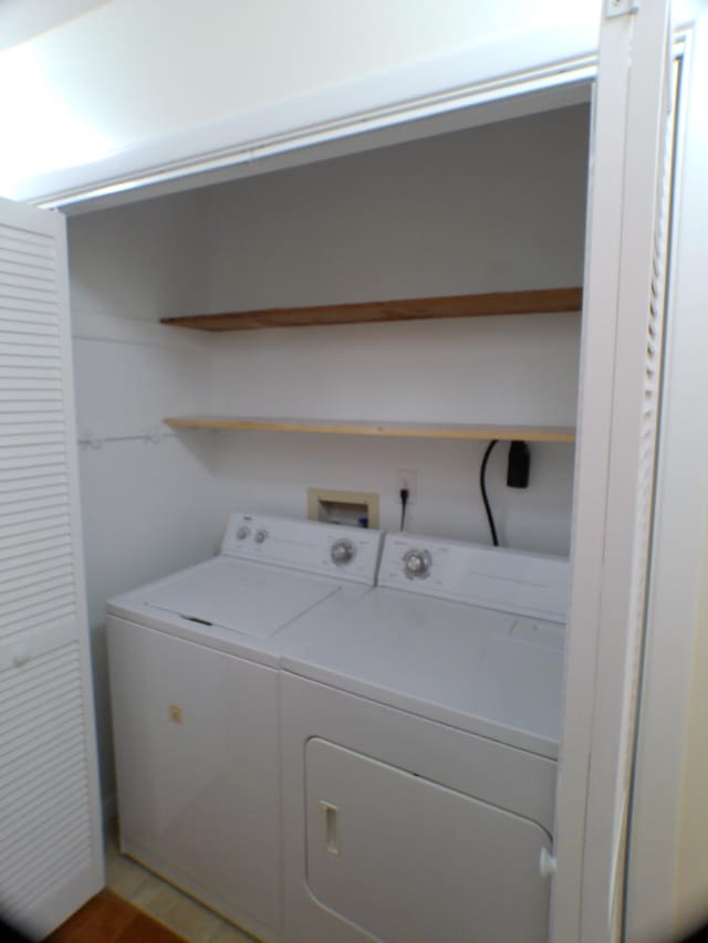 clothes washing area featuring separate washer and dryer