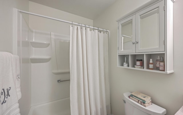 bathroom with shower / bathtub combination with curtain and toilet