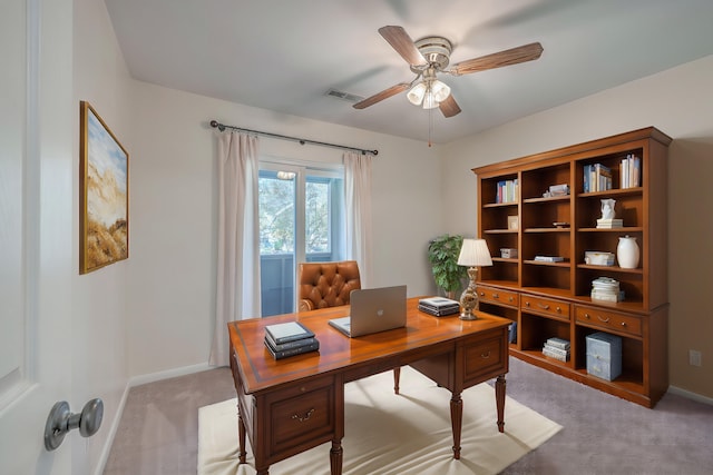 carpeted office space with ceiling fan