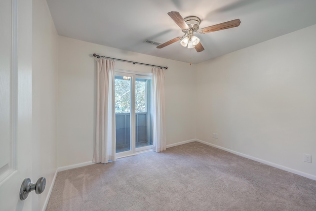 carpeted spare room with ceiling fan