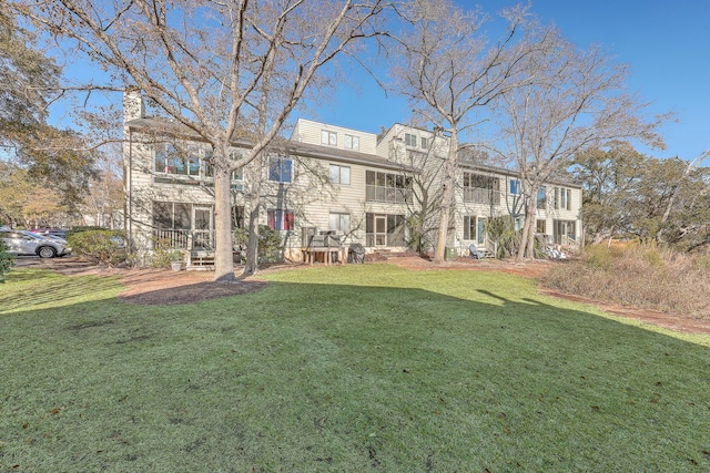 exterior space with a balcony and a yard