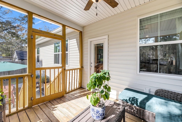 sunroom with ceiling fan and wood ceiling