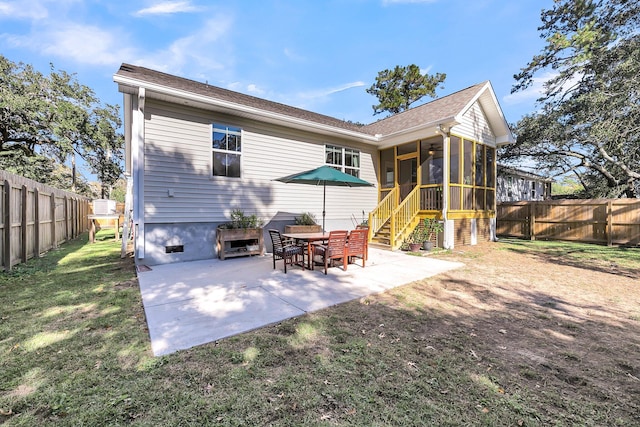 back of house with a yard, a patio, and a sunroom