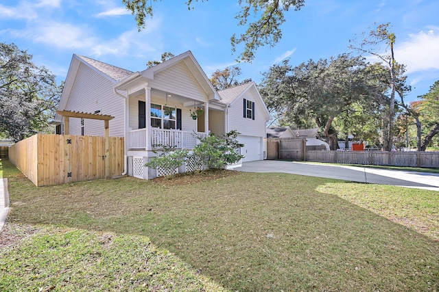 view of front of property with a front lawn, covered porch, and a garage