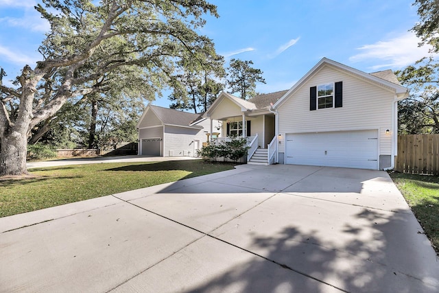 view of front of home featuring a front lawn, a porch, and a garage