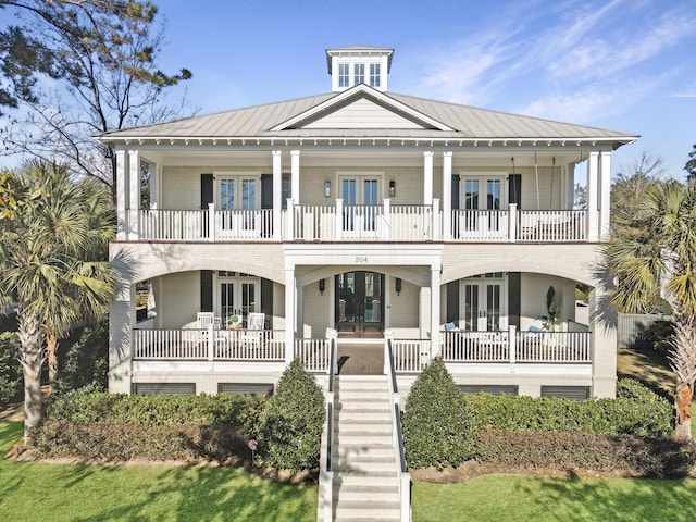 view of front facade with french doors and covered porch