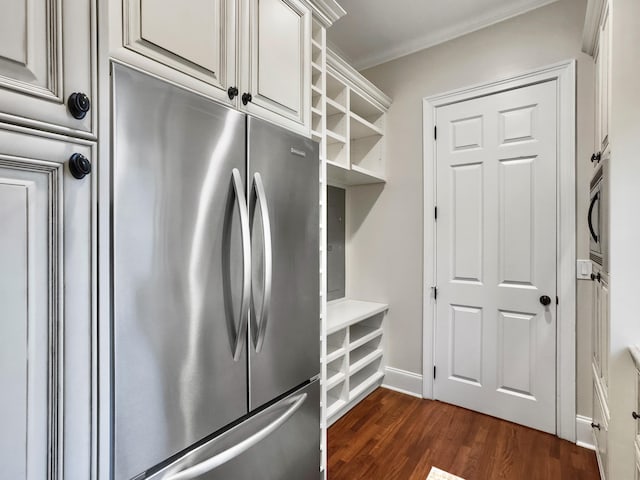 kitchen featuring appliances with stainless steel finishes, dark hardwood / wood-style floors, and crown molding