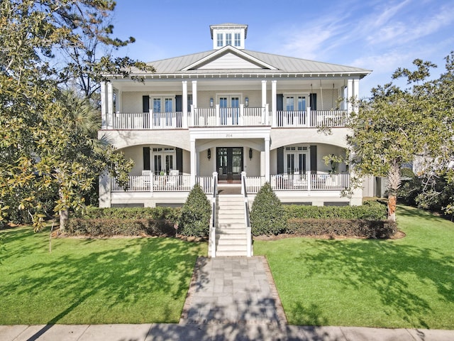 view of front of house featuring a front yard, french doors, and a porch